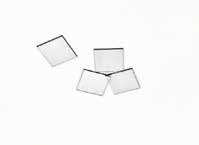 Four square single-crystal diamond cutting tool blanks on a white background.