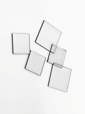 Five square single-crystal diamond plates arranged on a white background.